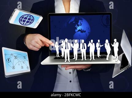 Donna d'affari che tiene oggetto sociale Foto Stock
