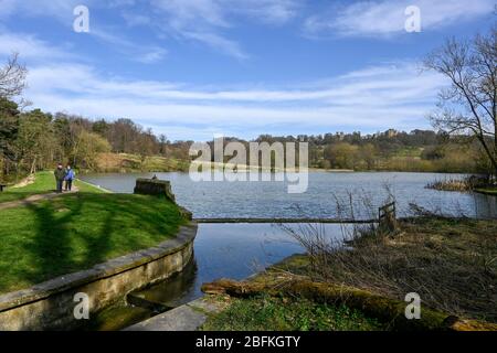 Coppia fuori a piedi vicino al lago a Hardwick Hall Derbyshire Inghilterra Foto Stock