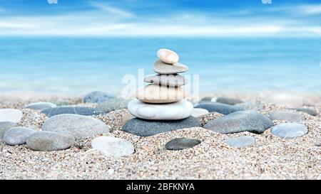 Torre di pietre sullo sfondo della spiaggia di mare Foto Stock