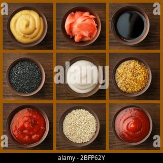 Set di salse diverse su sfondo di legno. Foto Stock