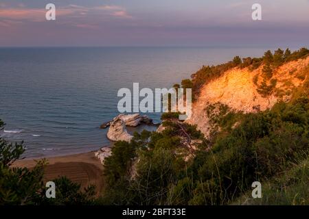 Costa e Spiaggia della Grotta del Bat al sole vicino Vieste sulla Penisola del Gargano, Italia Foto Stock