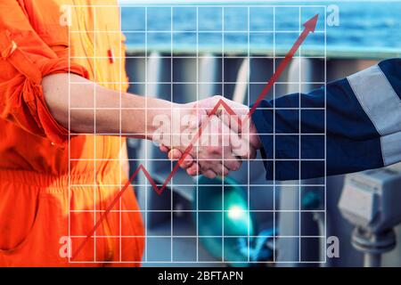 Concetto di crescita nell'industria marina con grafica in aumento. Imprenditore marino handshaking con il lavoratore Foto Stock