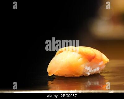 Akagai Sushi servito su piatto di legno nero. Corso di Omakase Giapponese. Foto Stock