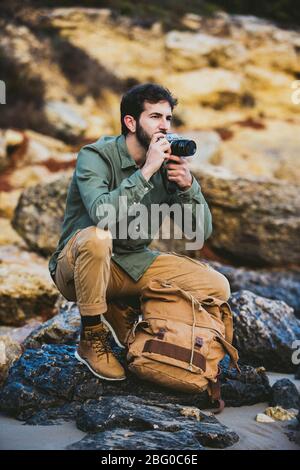 Ritratto di giovane uomo scattando foto all'aperto Foto Stock