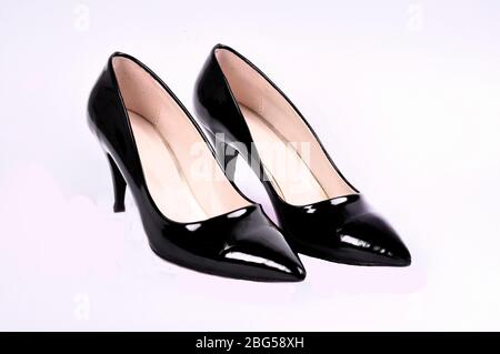 Belle scarpe eleganti per donna in pelle verniciata nera tacco alto su sfondo bianco. Foto Stock