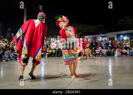 Ballerini in costumi colorati che eseguono la tradizionale danza peruviana Huayno Cusqueño alla folla nella piazza principale di Trujillo nel nord del Perù Foto Stock