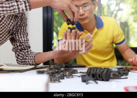 Ingegnere discutendo e progettazione circa la marcia meccanica parti in ufficio. Foto Stock