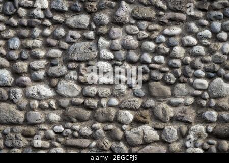 Muro di pietra naturale sullo sfondo Foto Stock