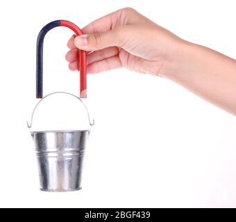 Magnete in mano che tiene il secchio di ferro piccolo isolato su bianco Foto Stock