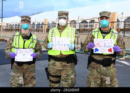 I militari e i militari della Guardia Nazionale del Massachusetts scattano una foto che rispondono insieme per aiutare le loro comunità durante la risposta del COVID-19. Forze di sicurezza Airmen della 104th Fighter Wing, Barnes Air National Guard base, Mass., e soldati con la 747th Military Police Company, Massachusetts Army National Guard, stanno fornendo 24 ore di sicurezza per i siti di test e rifugi per i senzatetto che possono essere positivi COVID-19. Gli Airmen e i Soldiers stanno lavorando con i partner interagency Springfield Police Department per garantire la sicurezza e la sicurezza per le forniture, i pazienti e il personale. Massa Foto Stock