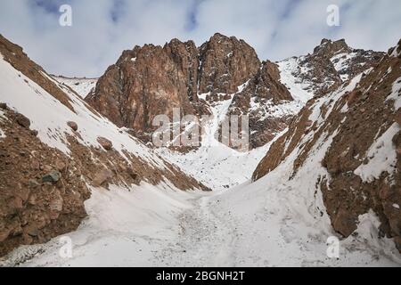 Alta montagna rocciosa con neve a Zaili Alatay gamma in Almaty, Kazakhstan Foto Stock