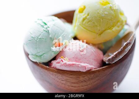 Palle di gelato naturale fresco e fresco fatto in casa o gelato nella ciotola di cocco biologico primo piano dietro l'altro Foto Stock