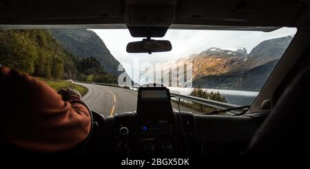 Guida attraverso le strade tortuose lungo i fiordi della Norvegia in un camper RV Van Foto Stock