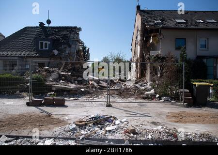 Colonia, Germania. 23 aprile 2020. Pezzi di macerie giacciono davanti alle case danneggiate. Dopo l'esplosione di una casa e la successiva scoperta di un cadavere a Colonia, l'indagine continua. La casa di schiera nel distretto di Buchheim era stata completamente distrutta dall'esplosione. Credit: Federico Gambarini/dpa/Alamy Live News Foto Stock