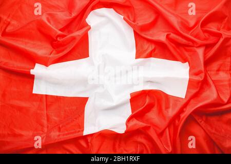 Sfondo della bandiera della Svizzera. Bandiera nazionale svizzera simbolo di democrazia, patriota. Texture closeup bandiera svizzera. Foto stock Croce Rossa Foto Stock