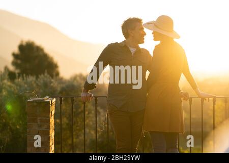 Coppia godendo la vista del tramonto in campagna, Orgiva, Andalusia, Spagna Foto Stock