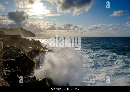 Spagna, Gipuzkoa, San Sebastian, onde che si infrangono contro la costa rocciosa Foto Stock