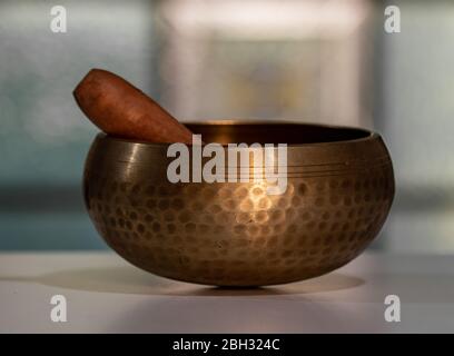 Campana tibetana in bronzo con bussello in legno. Foto Stock