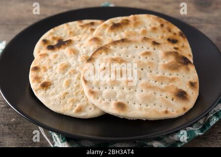 Matzah fatto a mano per la Pasqua ebraica su tavola di legno. Primo piano Foto Stock