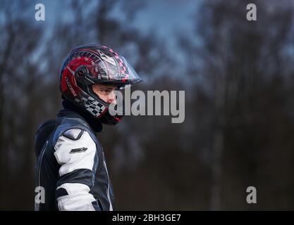 23-04-2020 riga, Lettonia. Motociclista in tuta protettiva con casco. Foto Stock