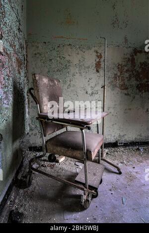 Sedia a rotelle in un ospedale abbandonato Foto Stock