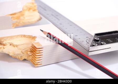 Builder disegna una linea con una matita su un pannello rotto per la riparazione, la costruzione di legno, costruire una casa Foto Stock