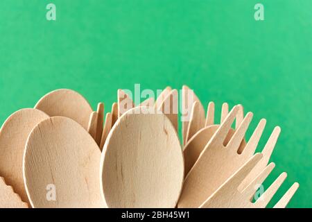 Posate eco di pino. Stoviglie monouso in materiali naturali. Cucchiaio di legno, forchetta e coltello su sfondo grecato. Foto Stock