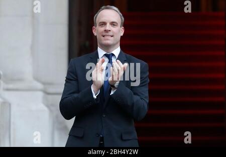 Il segretario degli esteri Dominic Raab si aggrappò al di fuori dell'ufficio degli Esteri e del Commonwealth di Londra per salutare gli eroi locali durante l'iniziativa Clap for Carers di giovedì per riconoscere e sostenere i lavoratori e gli operatori del NHS che combattono la pandemia del coronavirus. Foto Stock