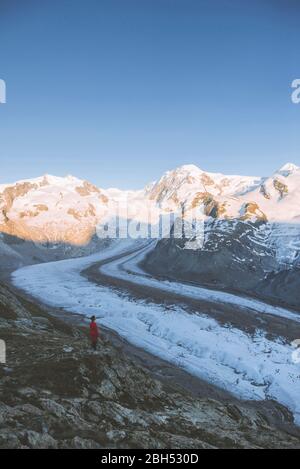 Donna in piedi sulla roccia del Ghiacciaio Gorner in Vallese, Svizzera Foto Stock