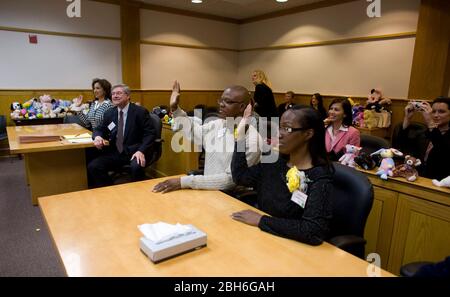 Austin, Texas 20 novembre 2008: Celebrando la Giornata nazionale di adozione nel Texas centrale sono state 24 le famiglie che hanno adottato i bambini nelle cerimonie festive presso la Corte giovanile della contea di Travis. Anthony (c) e Penora Giles (r) prestano giuramento in tribunale. ©Bob Daemmrich Foto Stock