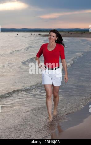 Austin, Texas 24 giugno 2009: Madre di trentotto anni di due che tiene fisicamente in forma passeggiate lungo una spiaggia nel Texas centrale. ©Bob Daemmrich Foto Stock