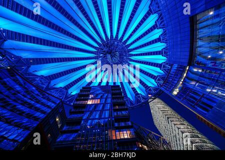 20 aprile 2020, Berlino: Il tetto a cupola ovale illuminato nel forum del Sony Center su Potsdamer Platz la sera. Il grattacielo della Deutsche Bahn è sulla destra. | utilizzo in tutto il mondo Foto Stock