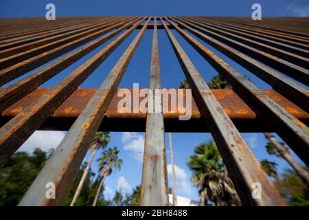 Brownsville, Texas USA, 7 ottobre 2009: Una sezione completa del muro di confine in cemento e acciaio non verniciato alto 20 metri attraverso il centro di Brownsville vicino al campus del Texas Southmost College. Il muro ha lo scopo di rallentare i valichi di frontiera illegali al valico del Rio Grande. ©Bob Daemmrich Foto Stock