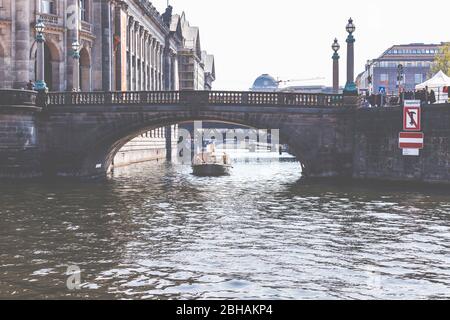 Una piccola barca passa sotto un ponte sulla Sprea al Museo di Bode. Foto Stock