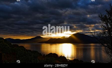 Alba sopra i suoni di Marlborough visto da Maud Island guardando verso la baia di Horseshoe, Nuova Zelanda. Foto Stock