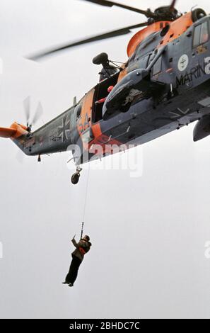 Sar Helicopter della Marina tedesca che raccoglie l'ispettore della Marina, Ansgar Bethge, e scorta alla nave da addestramento Deutschland, 26 maggio 1982, Mar Baltico, Germania Foto Stock