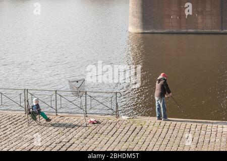 PRAGA, REPUBBLICA CECA - 31 OTTOBRE 2019: Nonno e nipote che pescano sul fiume Moldava nel centro di Praga. Il fiume Moldava è uno dei Foto Stock