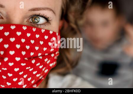 Ritratto di donna con maschera facciale in tessuto di cotone fatto a mano. Protezione contro saliva, tosse, polvere, inquinamento, virus, batteri, COVID-19. Foto Stock