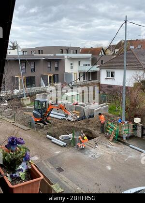 Parigi, Francia - 14 febbraio 2020: Cantiere aereo con lavoratori maschi e escavatori Hitachi vicino a nuovi appartamenti immobiliari Foto Stock