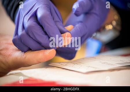 Pechino, Stati Uniti. 25 Aprile 2020. Un operatore sanitario prende un campione presso un centro di test anticorpali COVID-19 del New York state Department of Health presso il 9° mercato di Steve Street a Brooklyn, New York, Stati Uniti, 25 aprile 2020. Credit: Michael Nagle/Xinhua/Alamy Live News Foto Stock