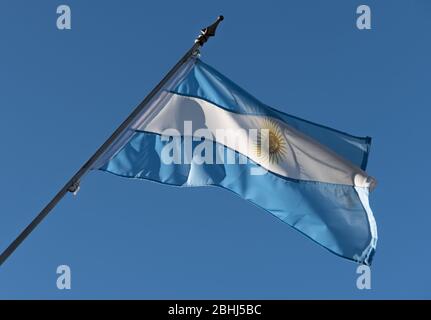 Argentino su un cielo blu e balbettando nel vento Foto Stock