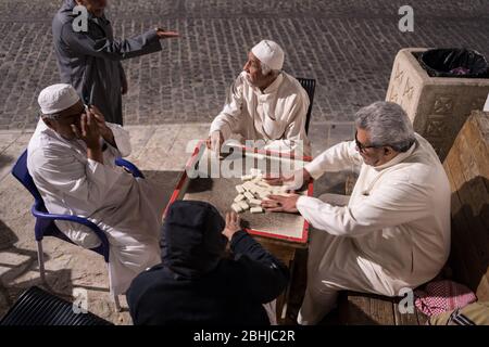 Jeddah / Arabia Saudita - 16 gennaio 2020: Vecchi uomini musulmani che giocano a domino di notte nelle strade della storica al-Balad Foto Stock