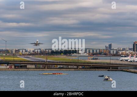 Volo aereo Embraer ERJ-190LR Mid-air, Helvetic Airways con partenza dall'aeroporto di London City (LCY). Vista dal basso. Inghilterra. Foto Stock