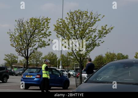 Il cliente Asda parla con il membro dello staff mentre indossa la maschera protettiva per il viso presso Asda Superstore durante il blocco dei coronavirus, Kingswood Retail Park, Hull Foto Stock