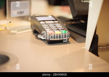 Terminale di pagamento al tavolo presso un enorme centro commerciale, concetto finanziario Foto Stock