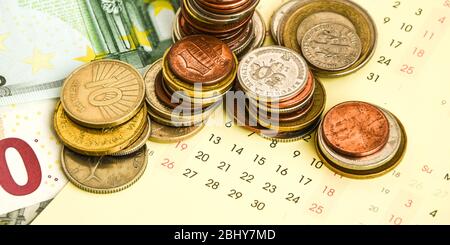 stack di monete sul calendario, closeup shot, per sfondo finanziario Foto Stock