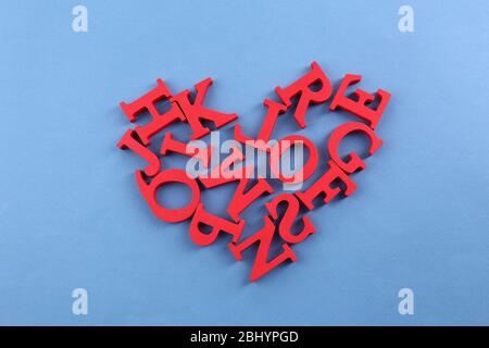 Lettere rosse a forma di cuore su sfondo blu Foto Stock