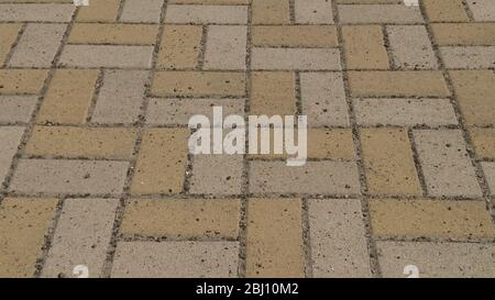 Vista prospettica della monotonia di mattoni grigi di pietra sul terreno per strada. Il marciapiede, Carraio, pavimentatrici, pavimentazione in Design Vintage pavimentazione Square Pa Foto Stock