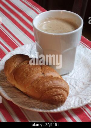 Tazza bianca di caffè su piastra con croissant - Foto Stock