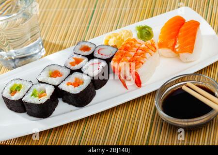 Piatto di sushi giapponese tradizionale. Hosomaki e makizushi con vari ripieni, nigiri con salmone e gamberi Foto Stock